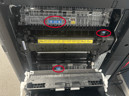 Inside Kyocera TASKalfa Paper Jam drawer with blue tabs indicating where jam is